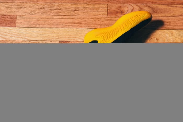 Side view of Anthony Edwards' yellow and black adidas sneakers.